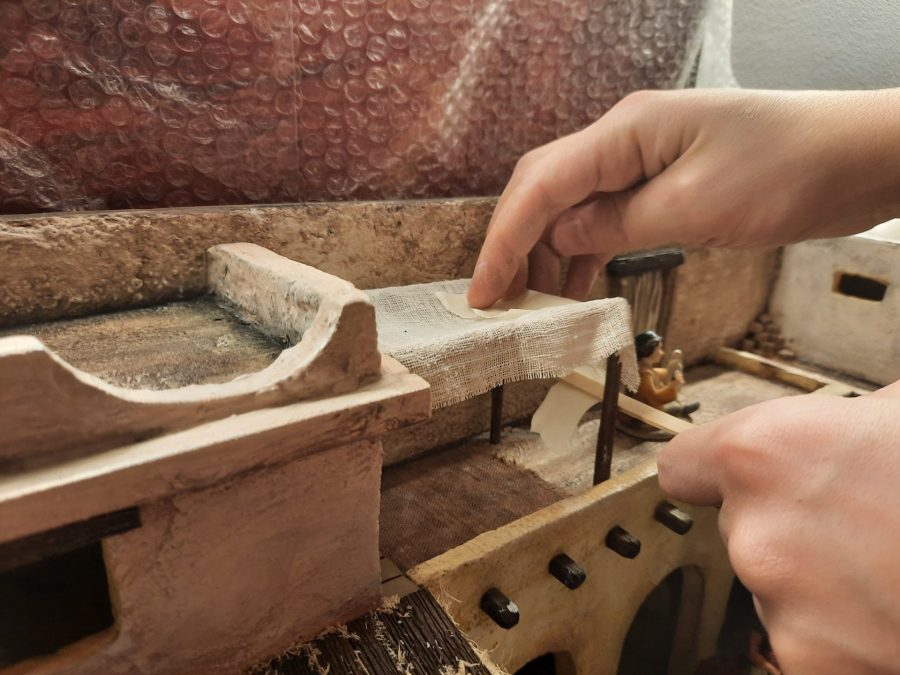 Making a Nativity diorama inside an antique steamer trunk: detailing the balcony above the porch to host the sculptor's canopy