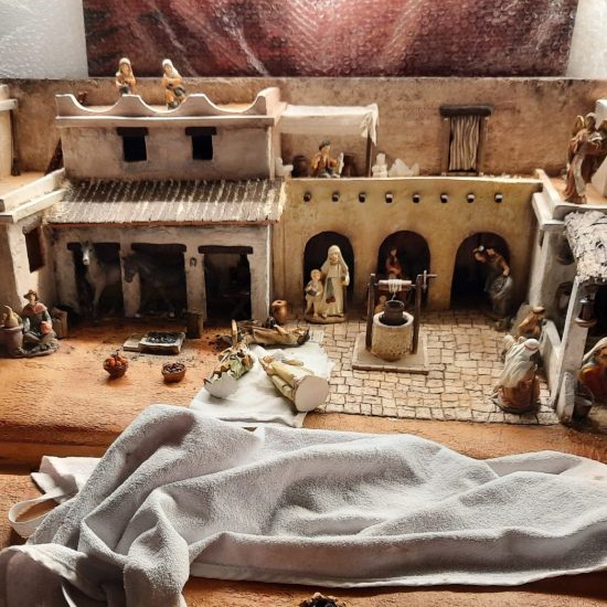 Making a Nativity diorama inside an antique steamer trunk. The town of Bethlehem with all its buildings and people, ready to receive the final details.