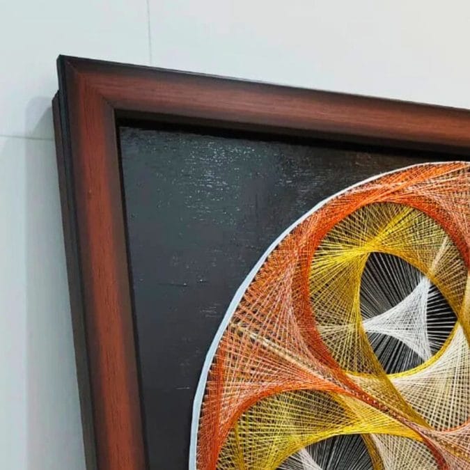 Example of a string art piece mounted in a floater frame