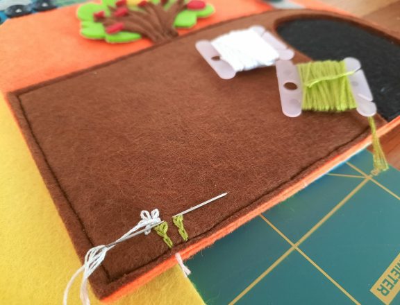 Making our felt bus book: adding flowers to the tunnel