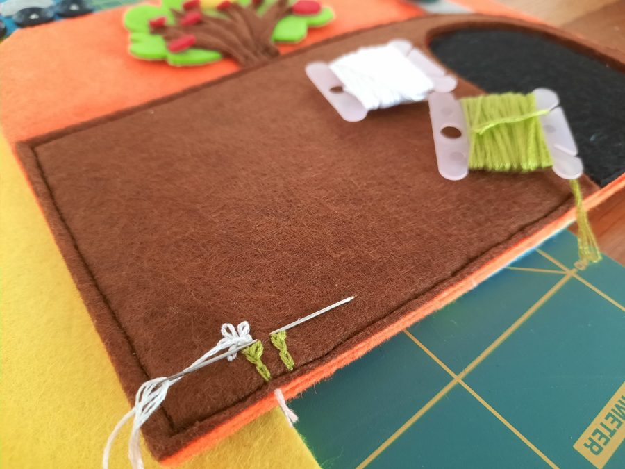 Making our felt bus book: adding flowers to the tunnel