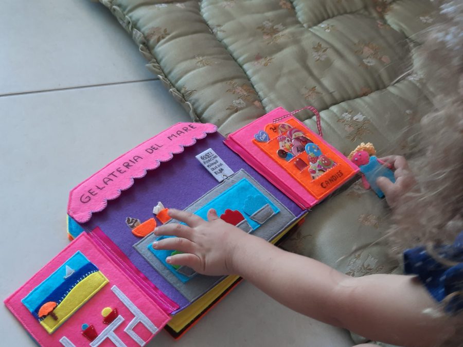 MJy daughter playin with her felt busy book "Train trip to the seaside"