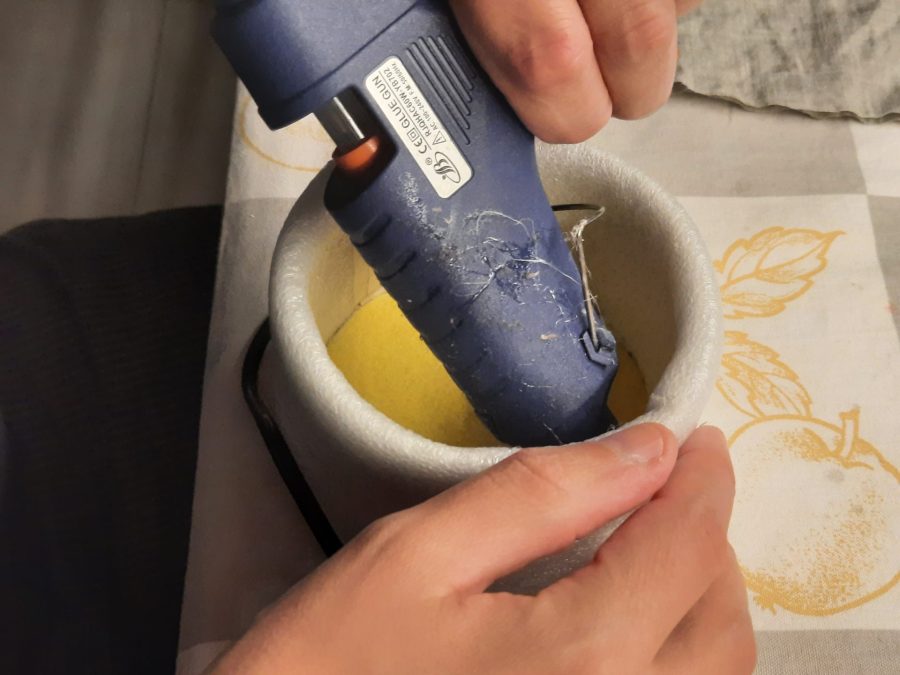 Upholstering the metal tin to protect the fabric
