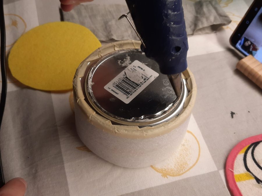 Upholstering the metal tin to protect the fabric