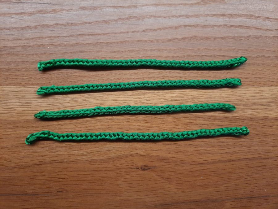 Making the octopus toy with the lucet: make four equal length cords to obtain eight tentacles