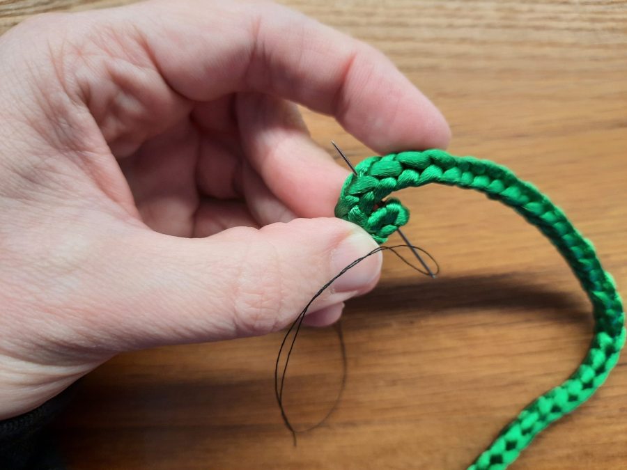 Making the snail toy with the lucet: sew a spiral to make the shell