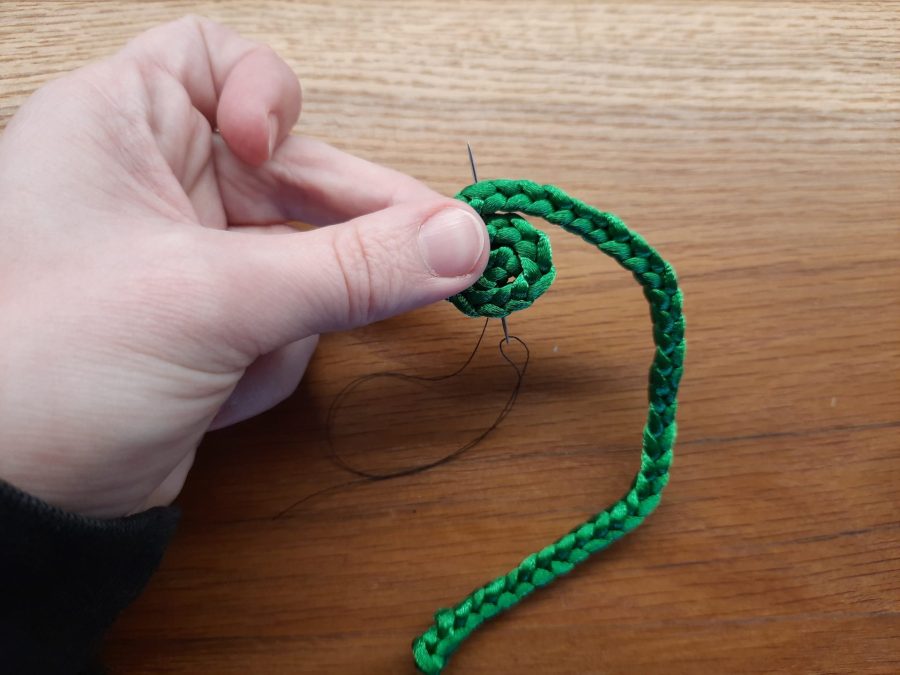 Making the snail toy with the lucet: sew a spiral to make the shell