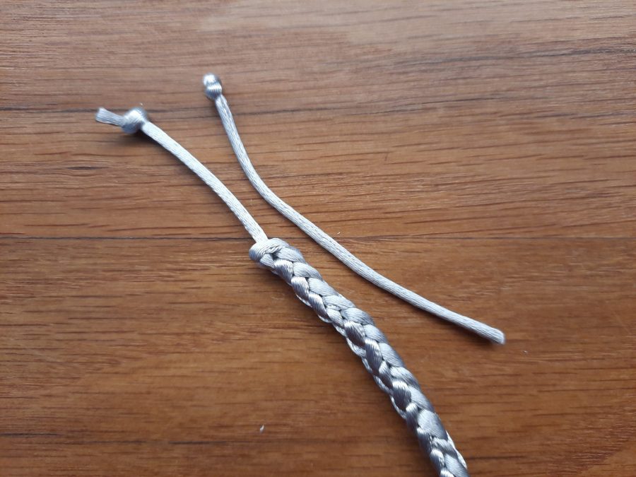 Making the snail toy with the lucet: add a second tail to one end to make the second antenna