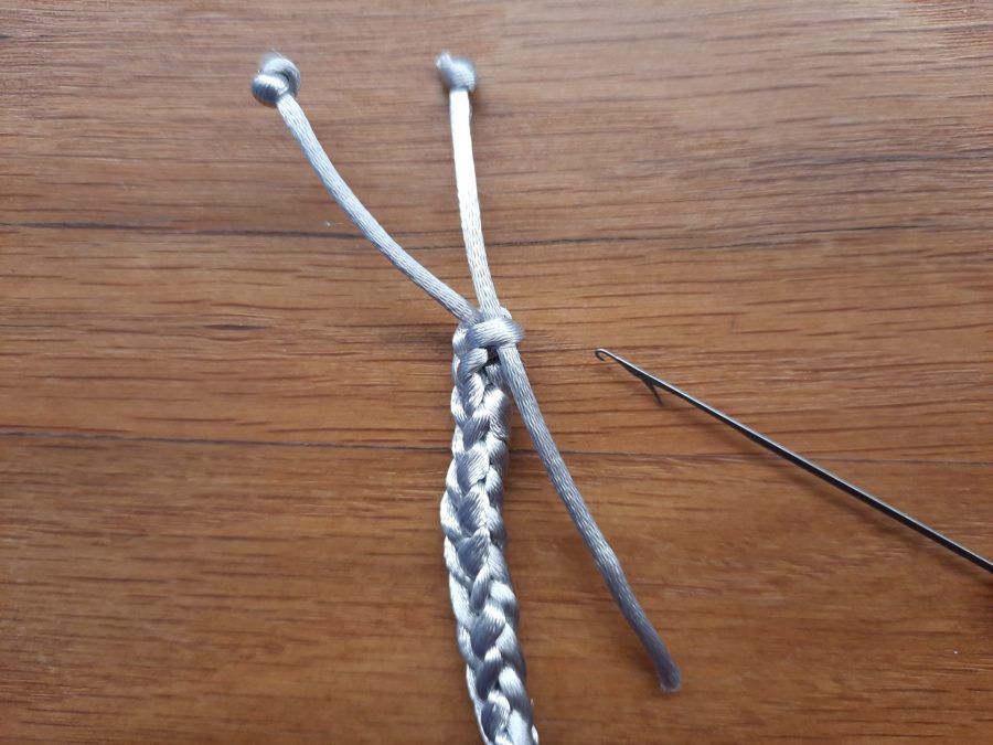 Making the snail toy with the lucet: add a second tail to one end to make the second antenna