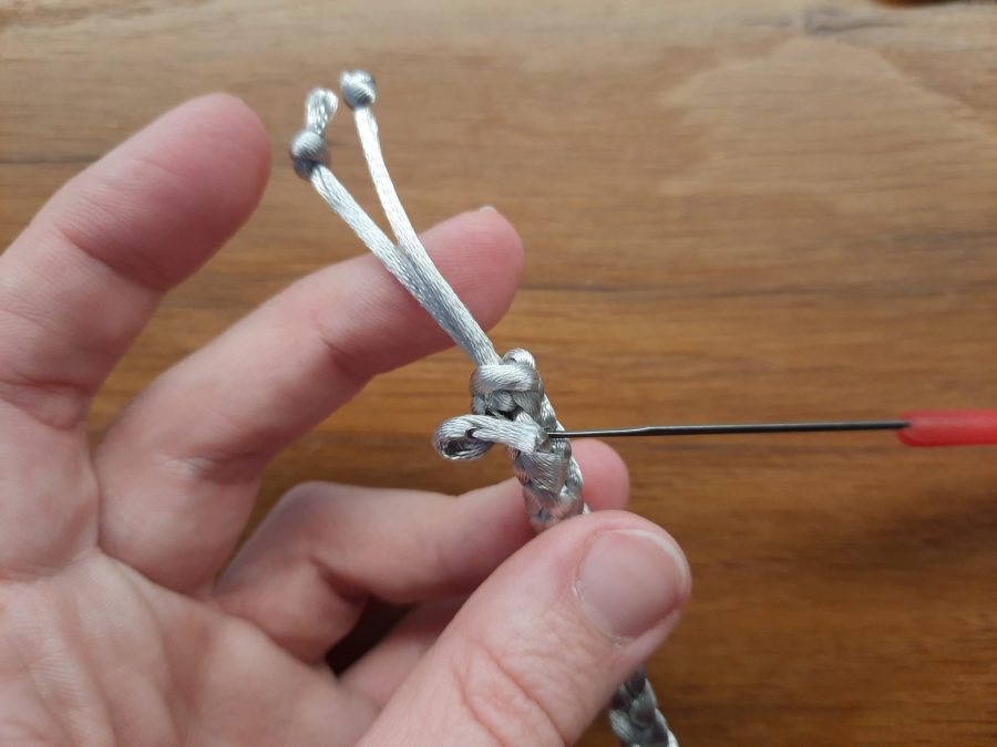 Making the snail toy with the lucet: add a second tail to one end to make the second antenna