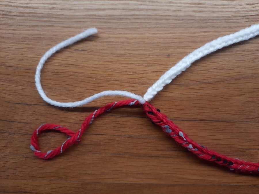 How to make a toy lollipop with the lucet: start by securing the two ends of your cords with a knot