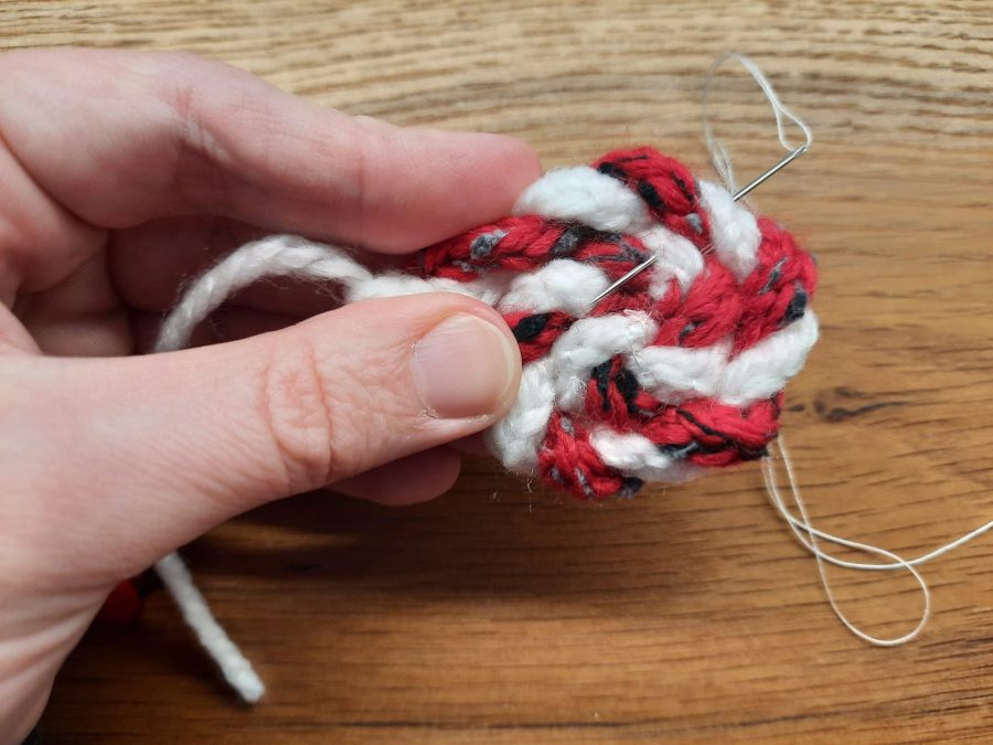 How to make a toy lollipop with the lucet: as you twist the cords, sew them in place in a spiral