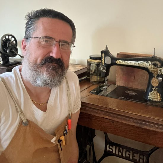 Darren, the founder of The Sewing Machine Orphanage, with her grandmother's sewing machine